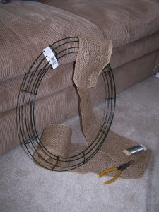 My supplies for step one: wreath frame, burlap, wire and wire cutters.